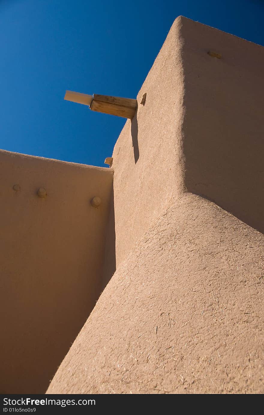 Adobe building roof view with blue sky behind. Adobe building roof view with blue sky behind