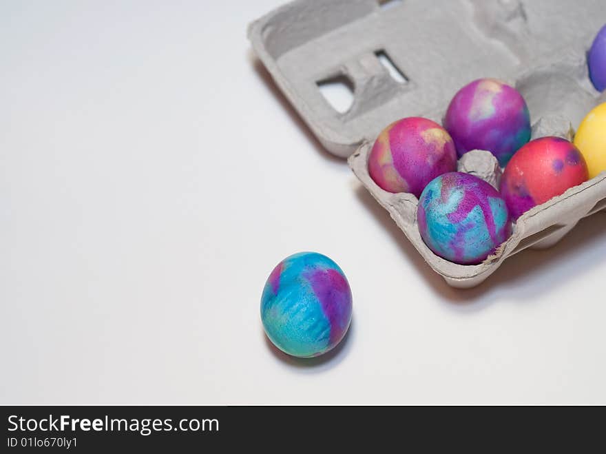 Six died Easter eggs in a cardboard carton isolated on white. Six died Easter eggs in a cardboard carton isolated on white