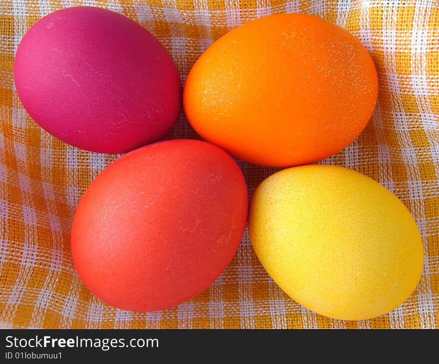 Traditional color Easter eggs on yellow checkers tablecloth