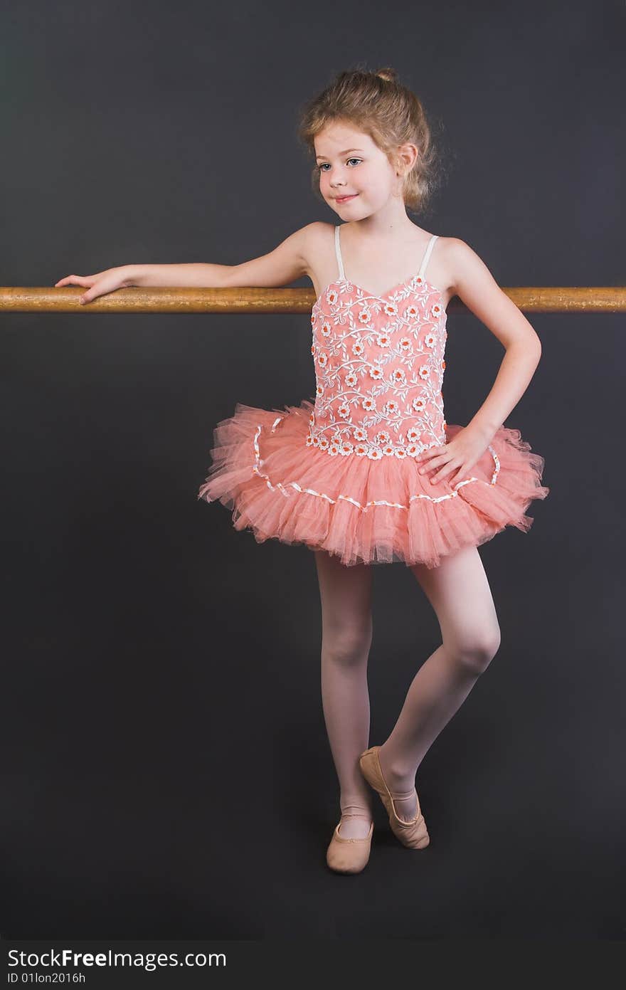 Young ballet dancer wearing an apricot tutu. Young ballet dancer wearing an apricot tutu