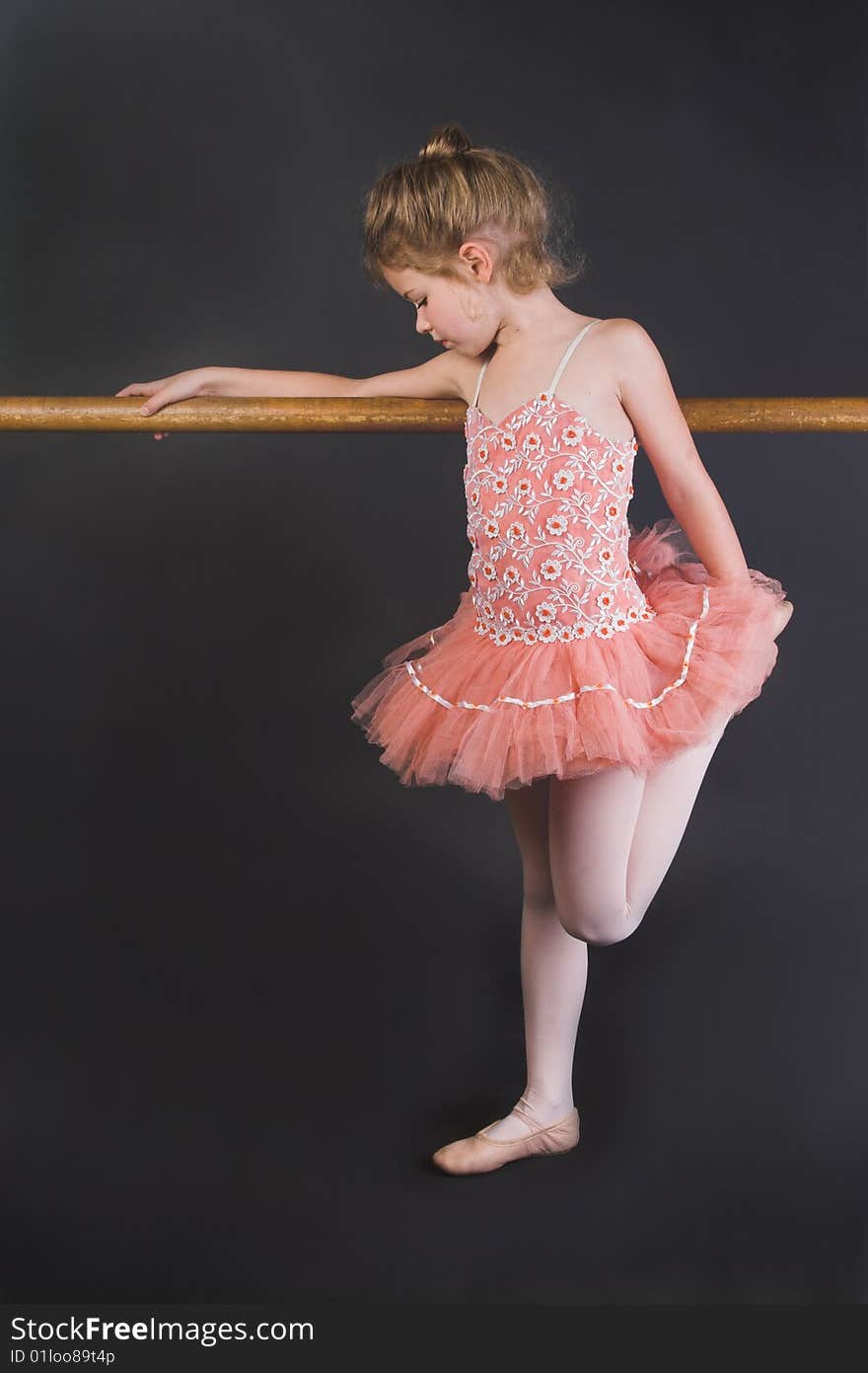 Young ballet dancer wearing an apricot tutu. Young ballet dancer wearing an apricot tutu