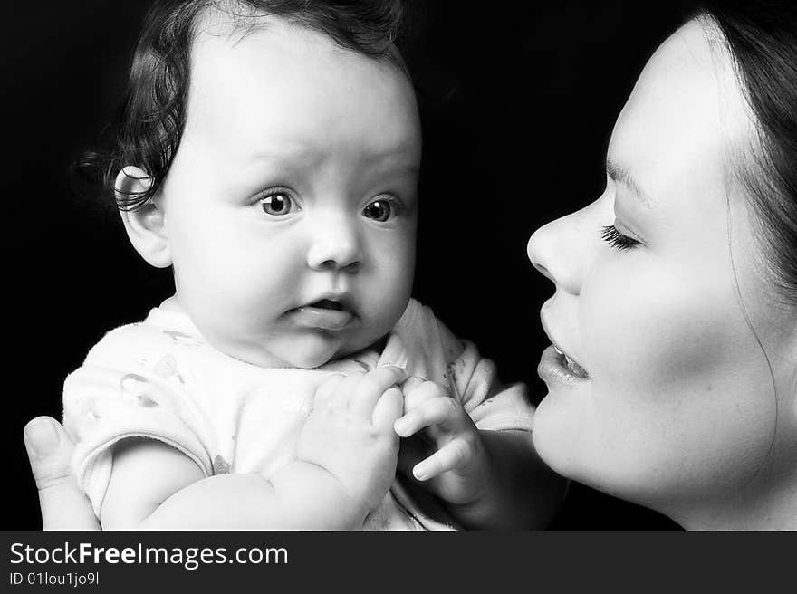 Mother and Baby Girl on a black background. Mother and Baby Girl on a black background