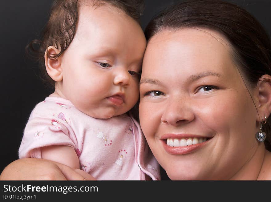 Mother and Baby Girl on a black background. Mother and Baby Girl on a black background