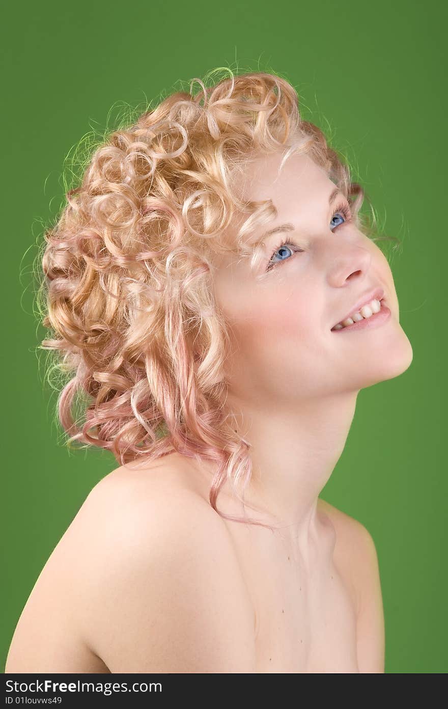 Portrait of a beautiful sexy woman with professional hair-style on green background