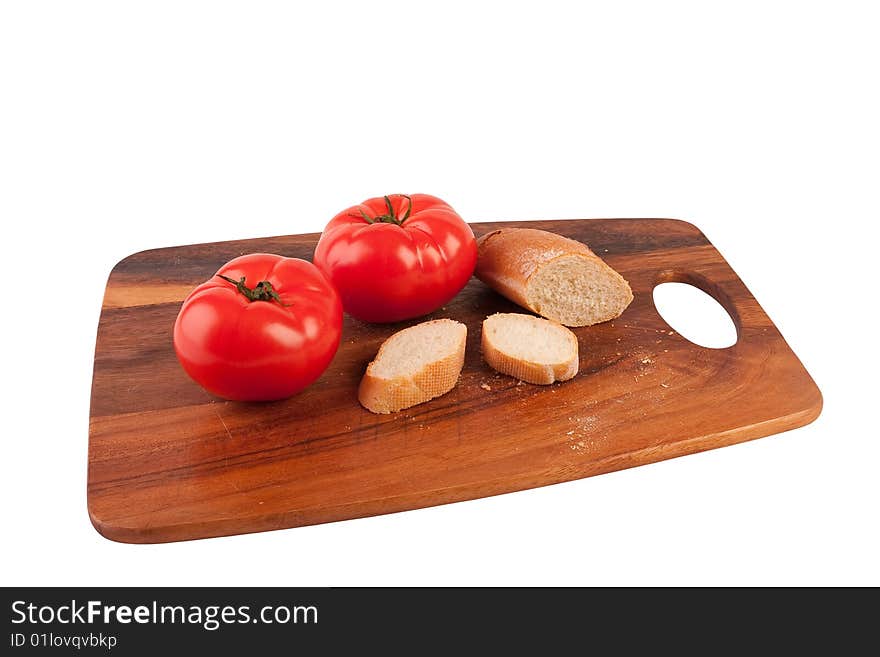 Two tomatoes and slices of baguette