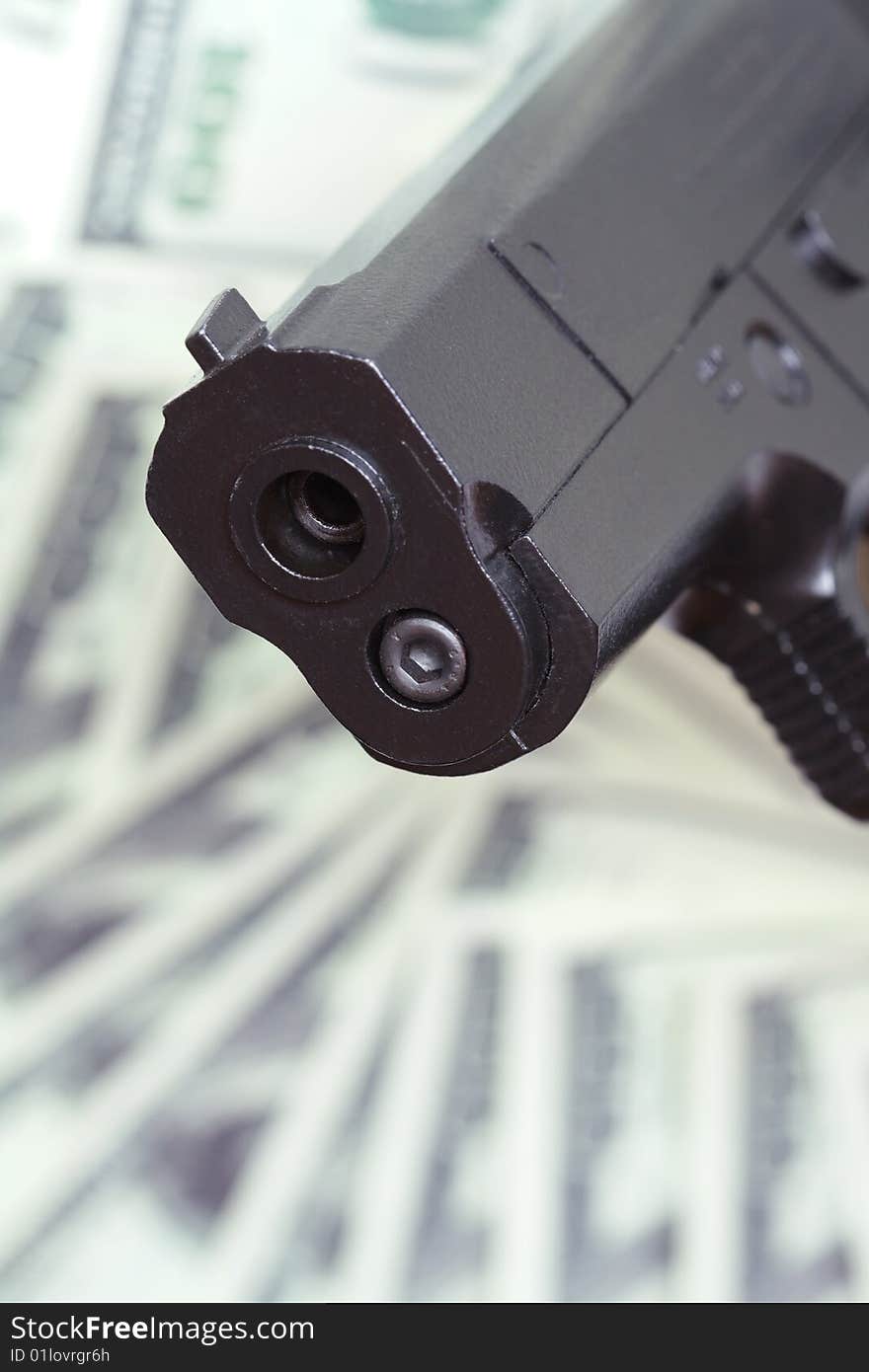 Close-up of automatic pistol on background with money. Close-up of automatic pistol on background with money