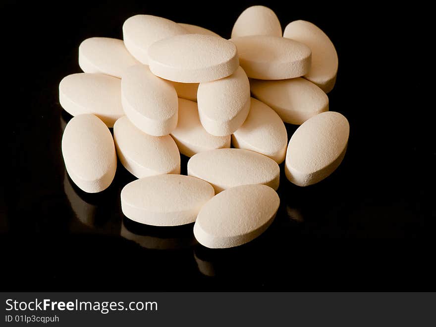 Colored oblong pills on the isolated background