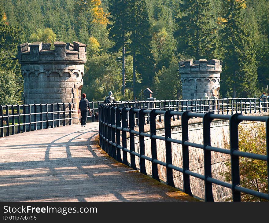 The path leading to the top of dam. The dam can hold flood water and used as drinking water supplies. Photos.