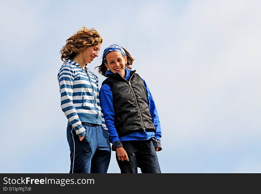 Teenage girlfriends chatting outdoors