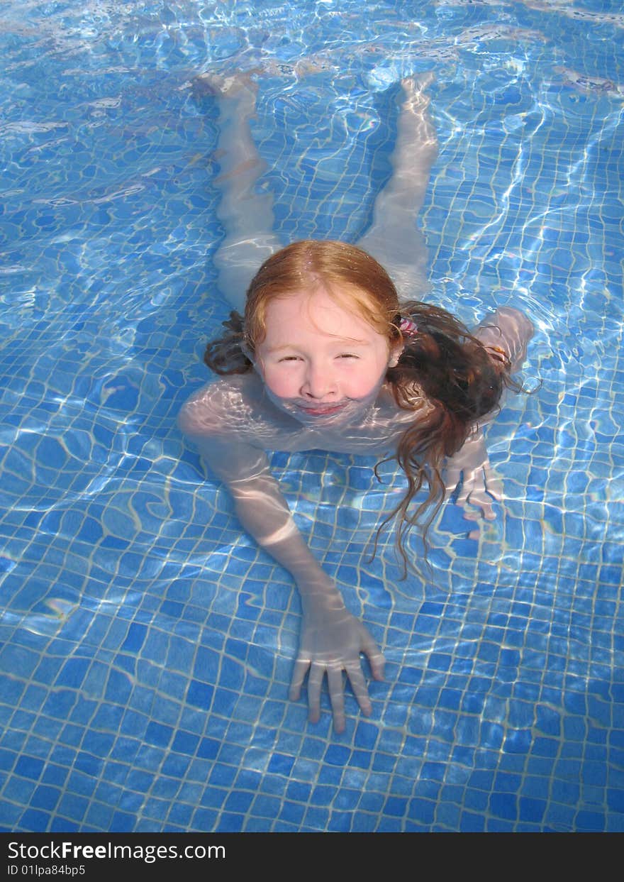 Young girl having fun bathing in a pool. Young girl having fun bathing in a pool.