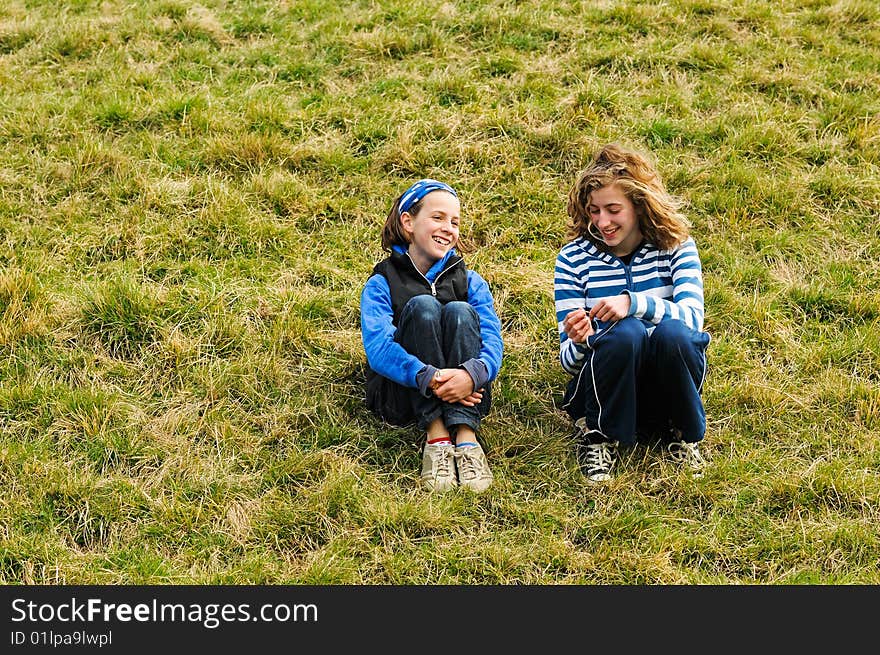 Portrait of two girls chatting outside. Portrait of two girls chatting outside