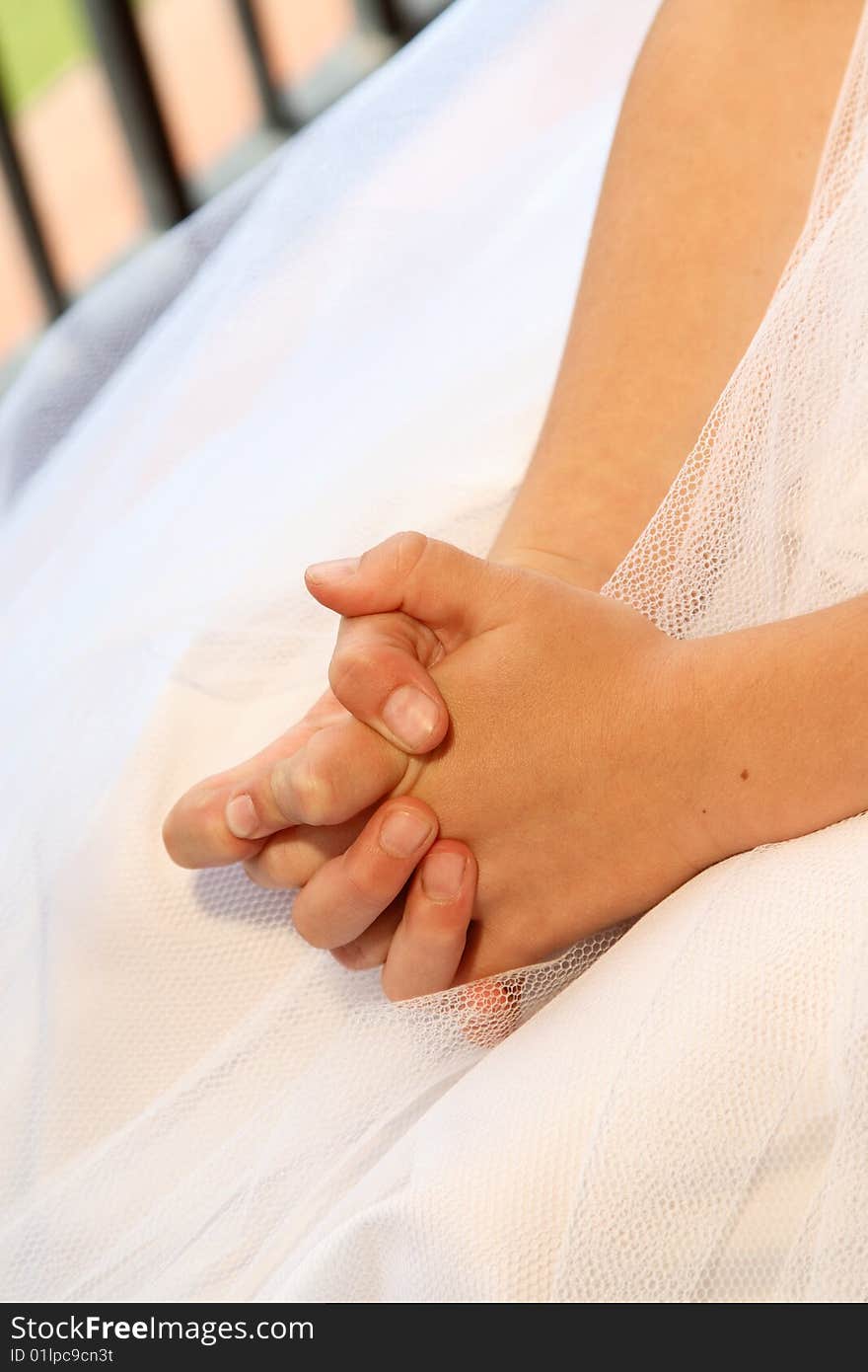 Young Bridesmaid sitting with her hands folded on her lap