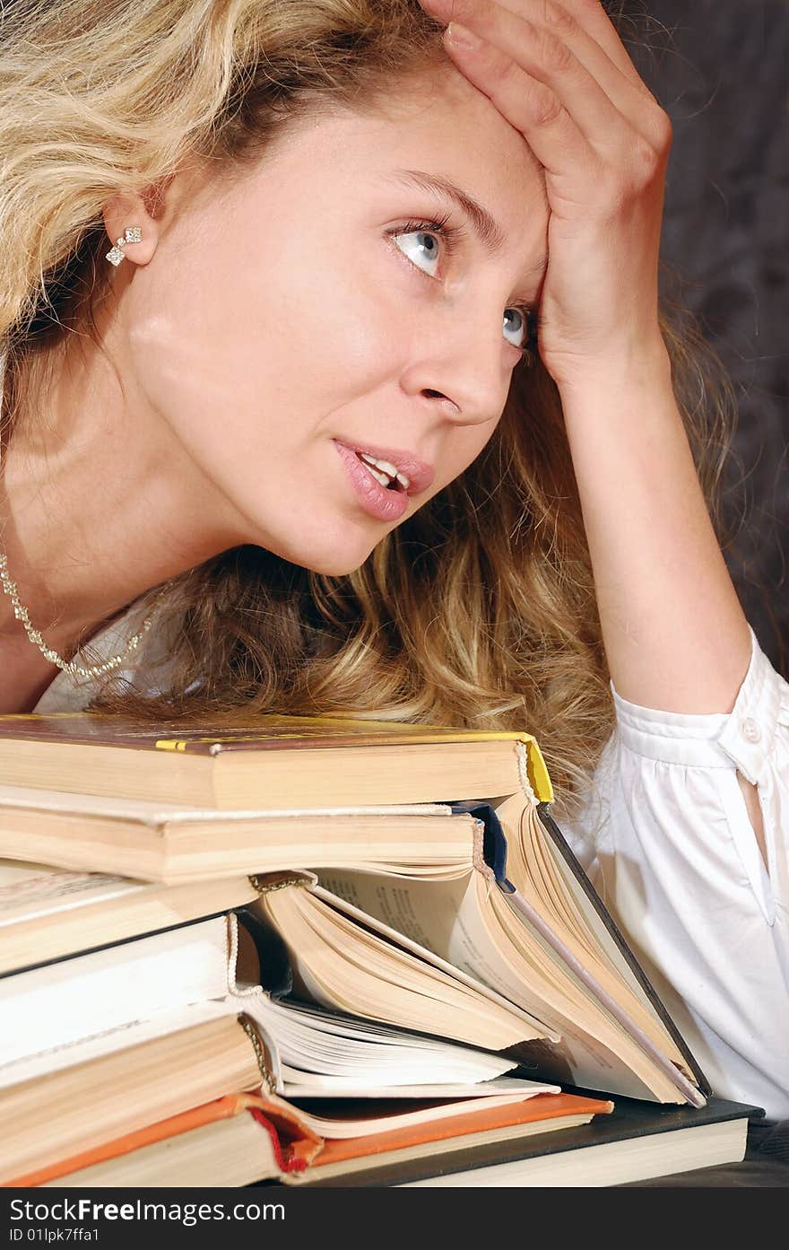 Young tired student with books. Young tired student with books