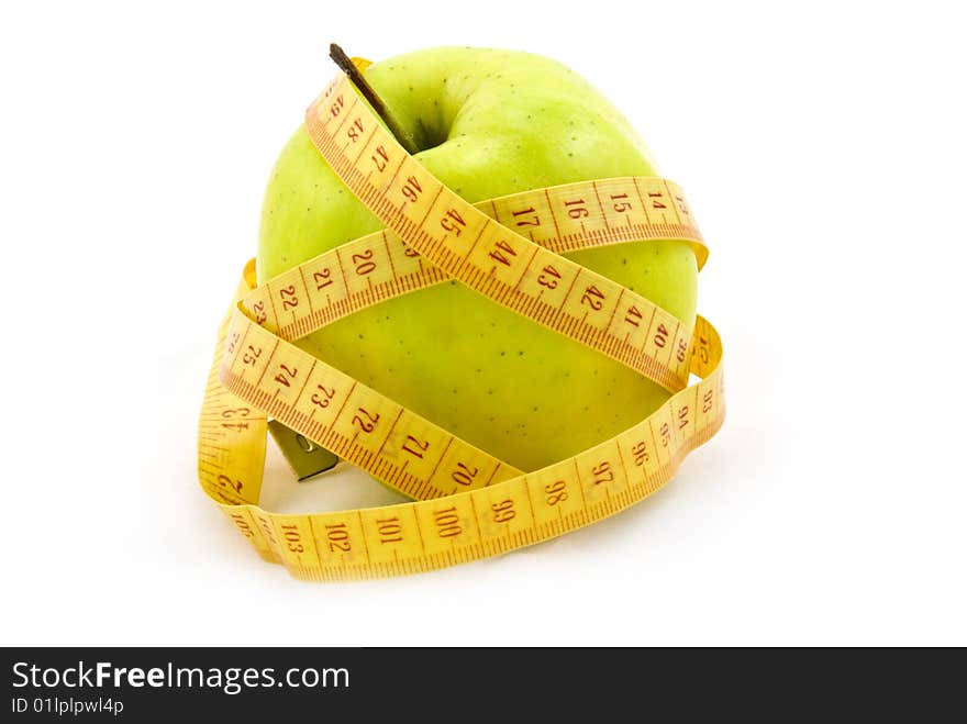 Green apple with a measure tape isolated on white background. Green apple with a measure tape isolated on white background