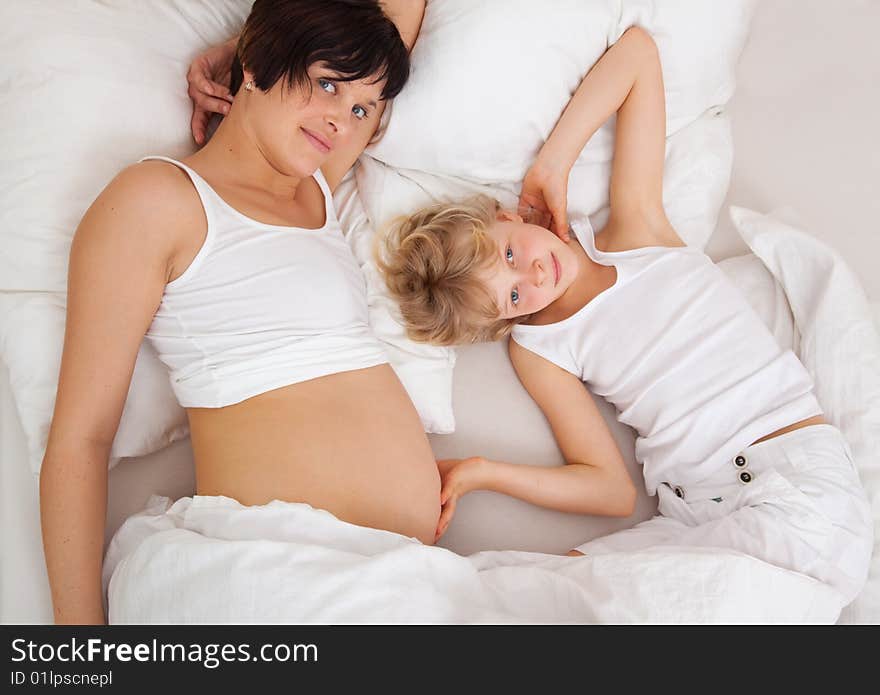 Youthful mama in bed with children. Youthful mama in bed with children