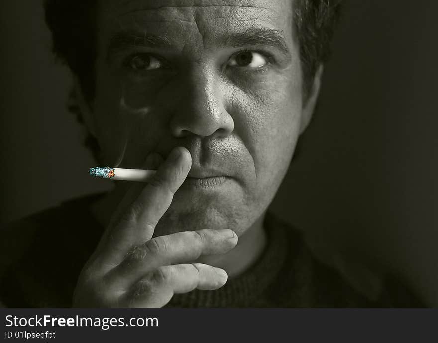 Portrait of a man smoking a cigarette. Portrait of a man smoking a cigarette