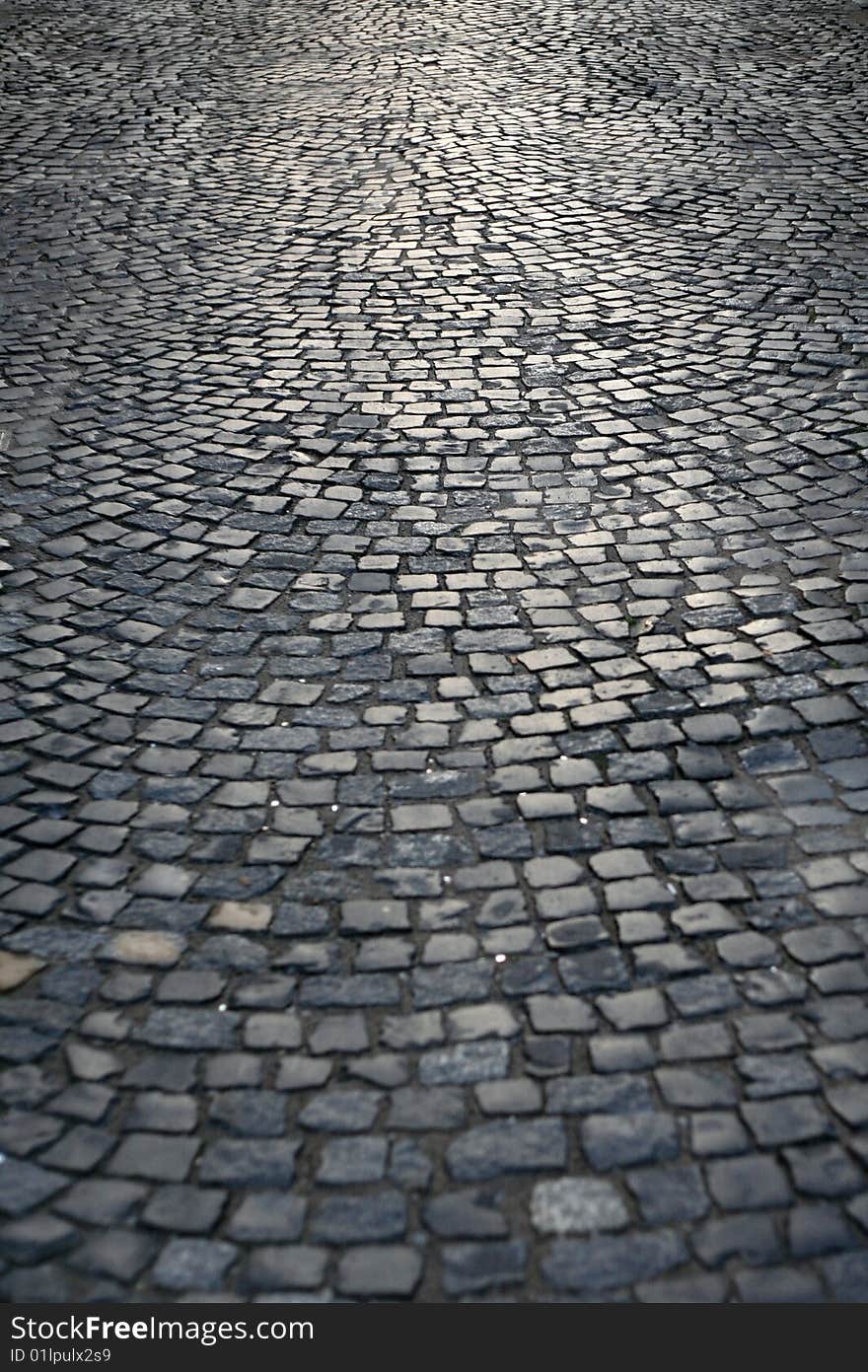 Old stone paved street, glare from lighting. Old stone paved street, glare from lighting