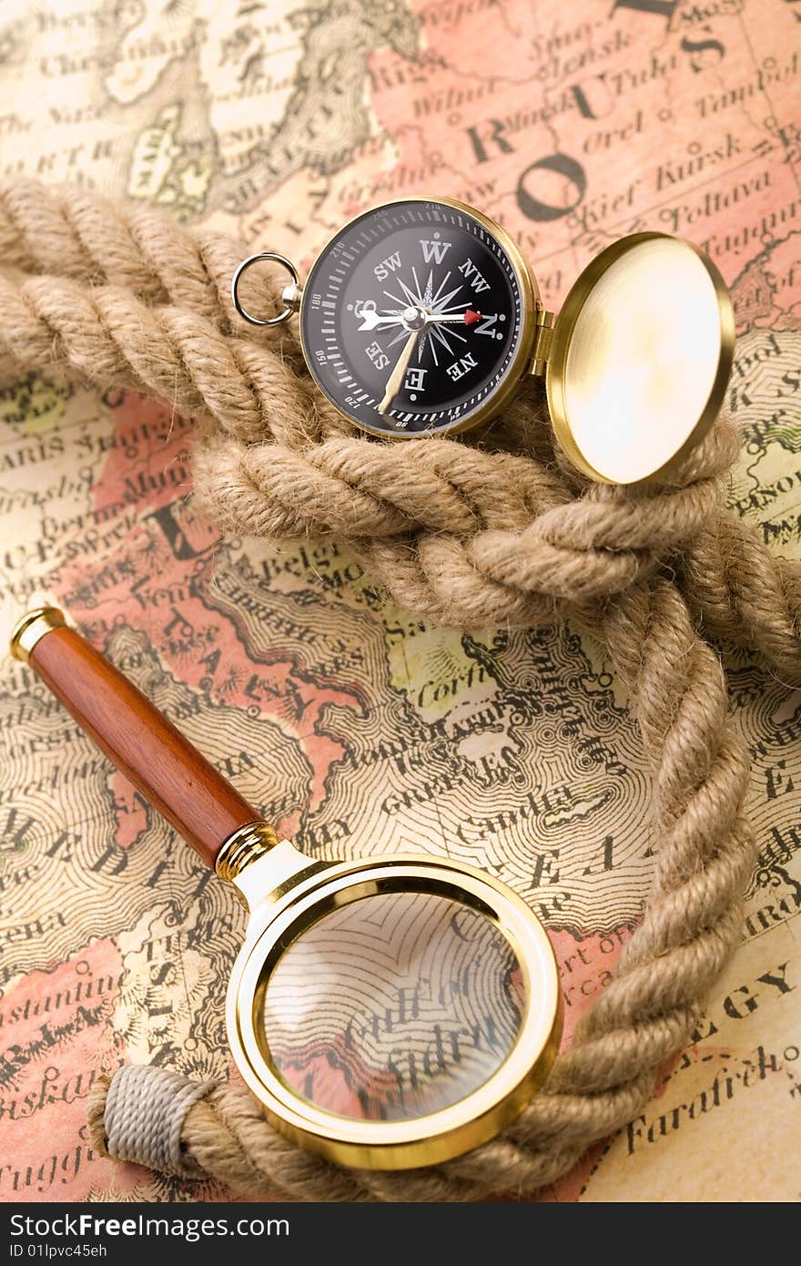 Old compass and magnifier