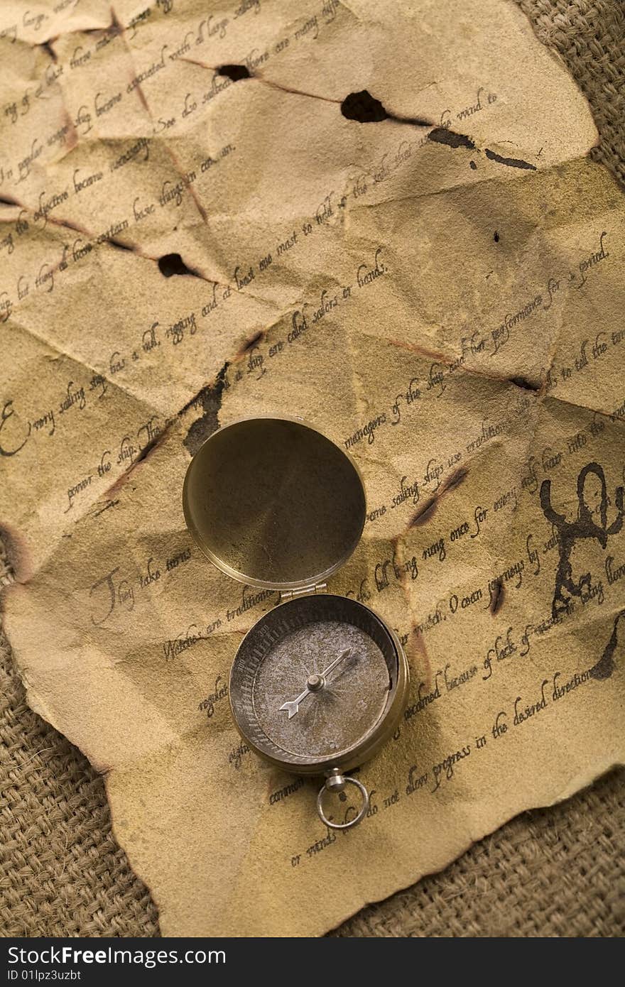 A beautiful old compass on an old letter