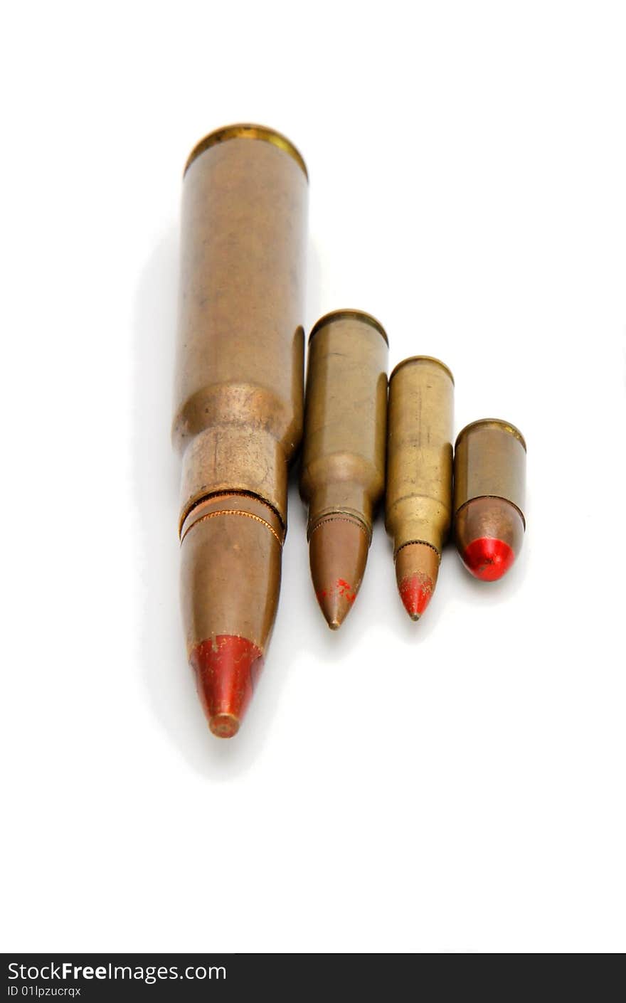 Four red-tipped tracer cartridges of various calibers isolated