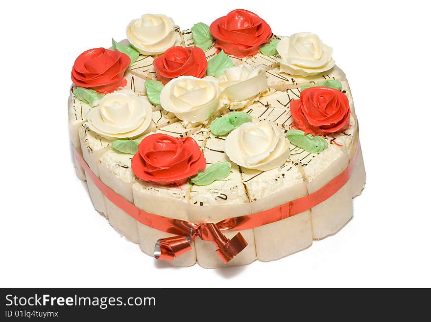 Festive cake decorated with cream roses and red ribbon. Festive cake decorated with cream roses and red ribbon