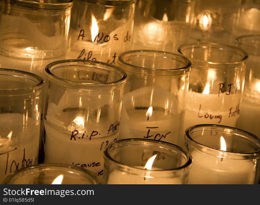 View of a bunch of lit candles in a church.