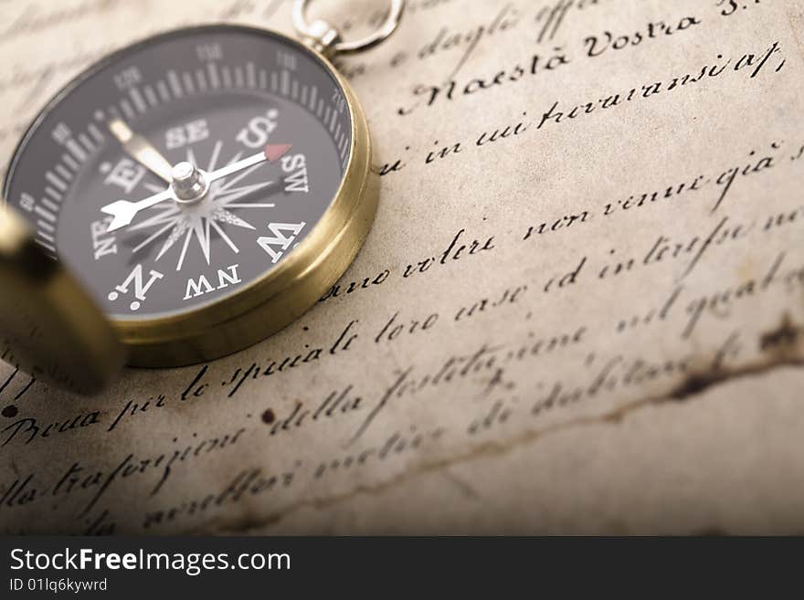 A beautiful old compass on an old letter