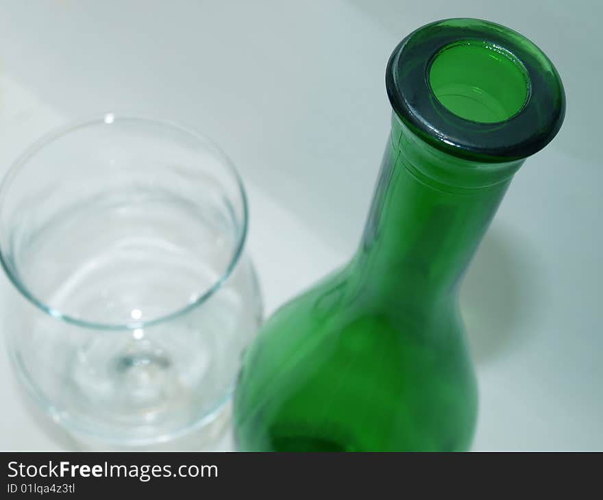 Color photograph wine bottles and glasses on a white tablecloth. Color photograph wine bottles and glasses on a white tablecloth.