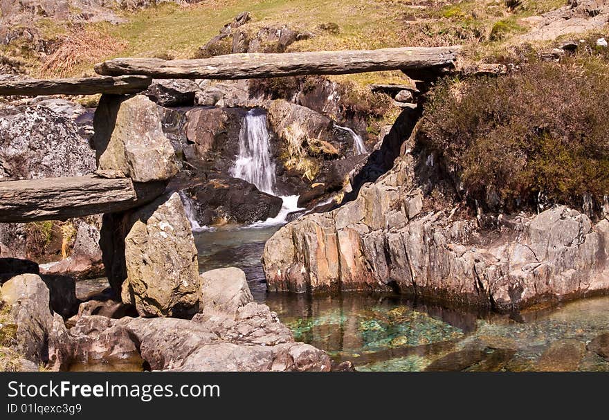 An narrow and ancient granite bridge spans the gorgeously clear rock pools below allowing the Watkin path to meander it's way up to snowdon, N.Wales. An narrow and ancient granite bridge spans the gorgeously clear rock pools below allowing the Watkin path to meander it's way up to snowdon, N.Wales