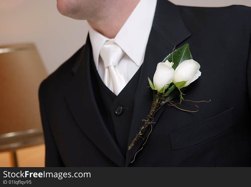 Groom wearing his wedding flower