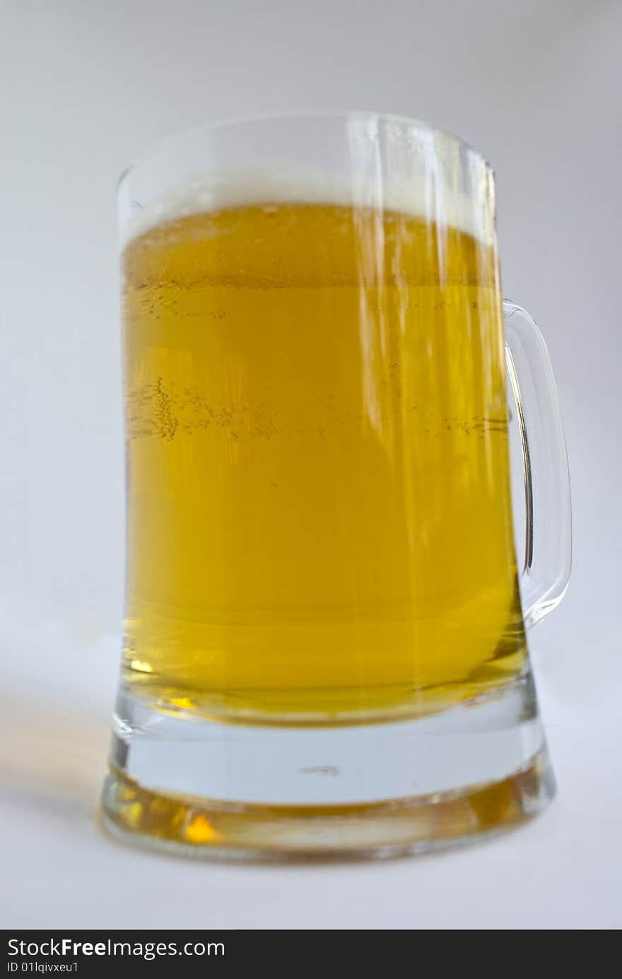 Glass of beer on a white background