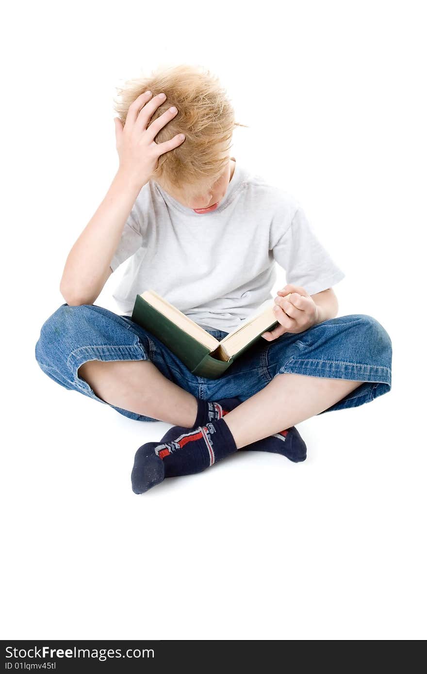 The boy reads on a white background. The boy reads on a white background