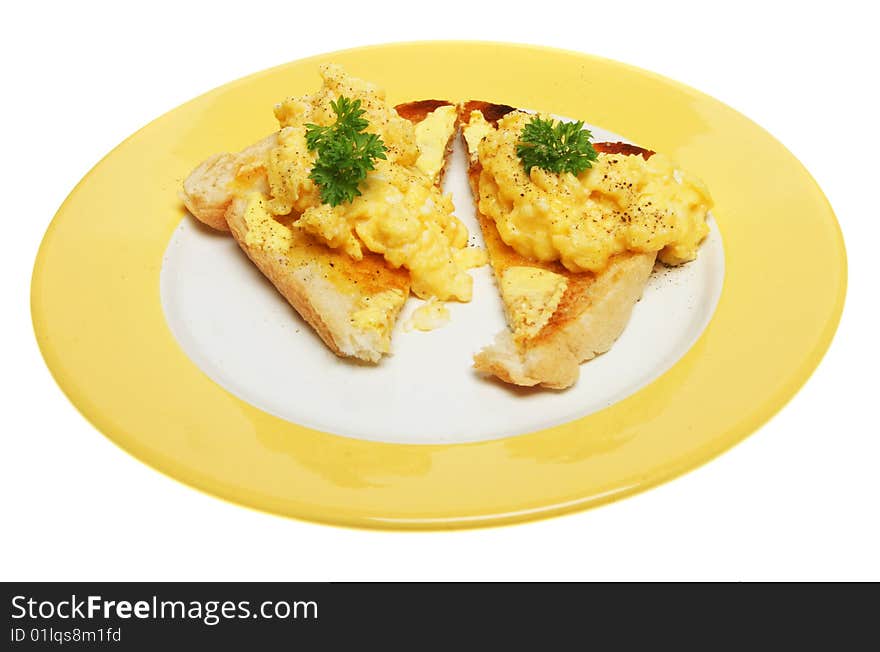 Scrambled eggs on toast on a yellow plate