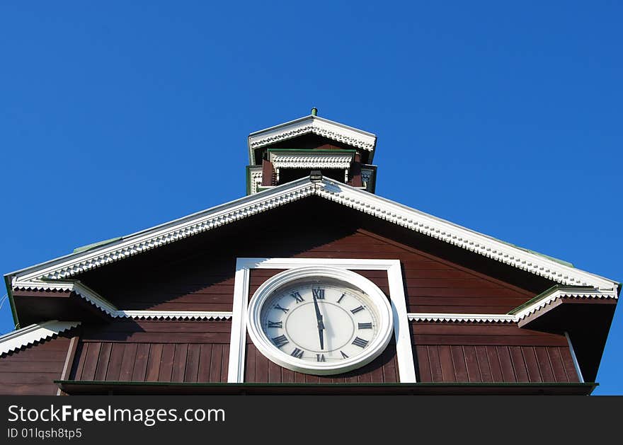 Roman numerals clock on old wooden chapel. Roman numerals clock on old wooden chapel