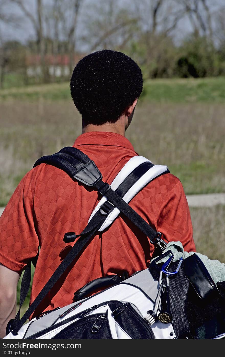 Young male golfer with carry bag. Young male golfer with carry bag.