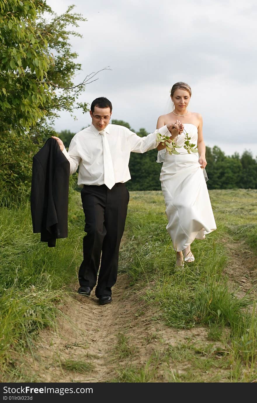 Young couple  in open air, photographic session in nature, pose for a photograph, take a shortcut