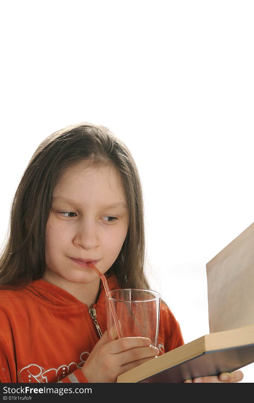 Young girl reading a book and drinking a fresh juice. Young girl reading a book and drinking a fresh juice