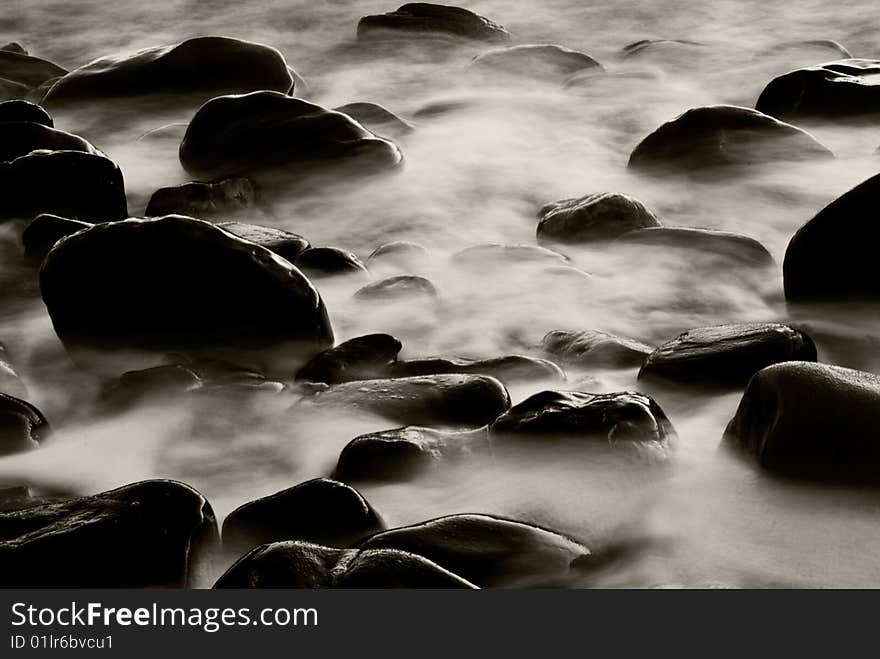 The capture of water rushing through rocks. The capture of water rushing through rocks.