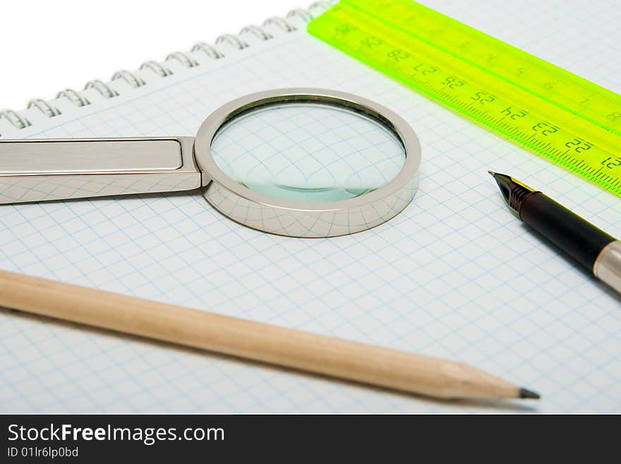 Fountain pen, magnifier, pencil and ruler isolated on the white. Fountain pen, magnifier, pencil and ruler isolated on the white