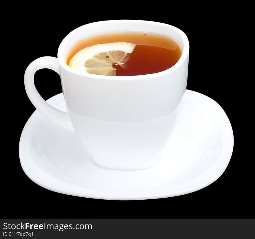 Cup of tea with lemon and saucer, isolated on black. Cup of tea with lemon and saucer, isolated on black