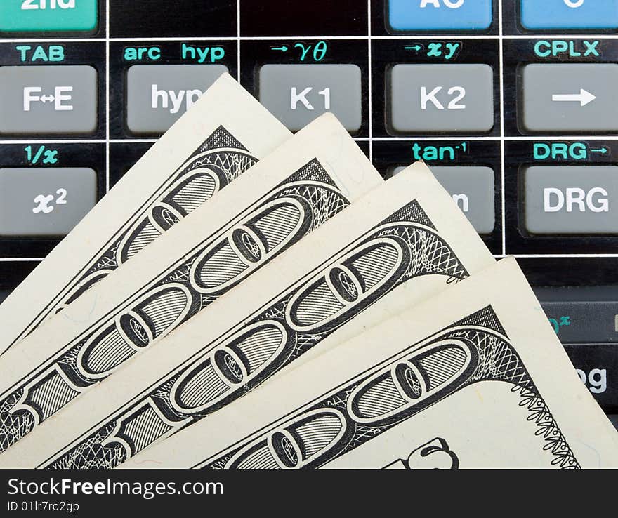 Close-up dollars over calculator