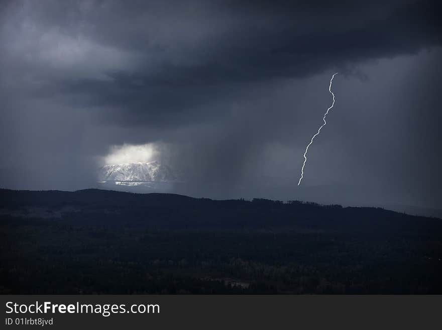 Lightning storm with sun breaking through in background. Lightning storm with sun breaking through in background