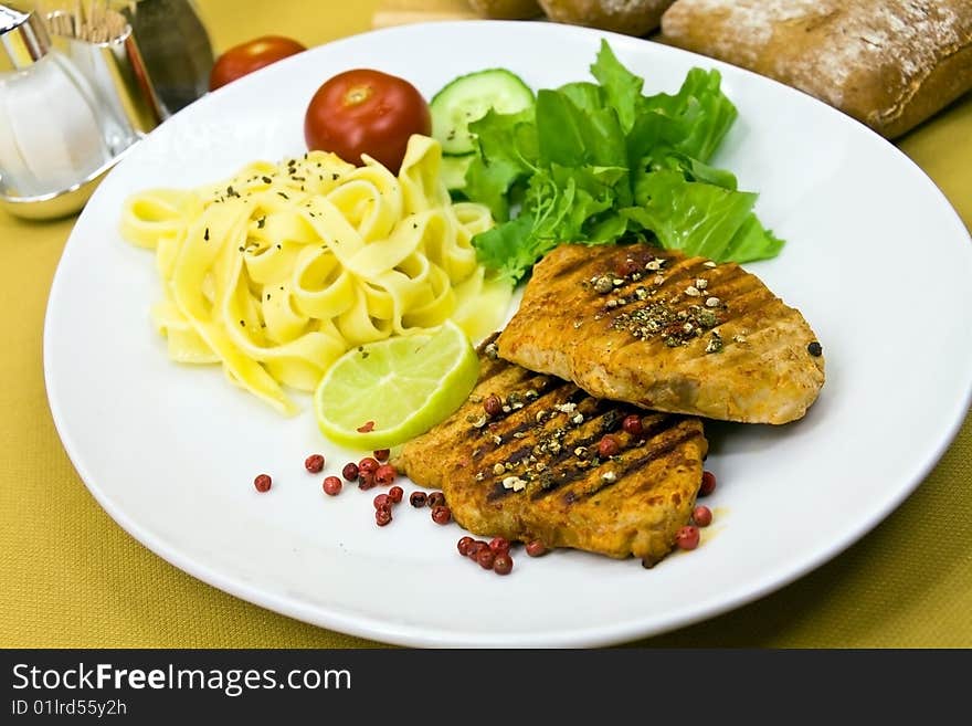 Grilled pork steak with noodles and lettuce