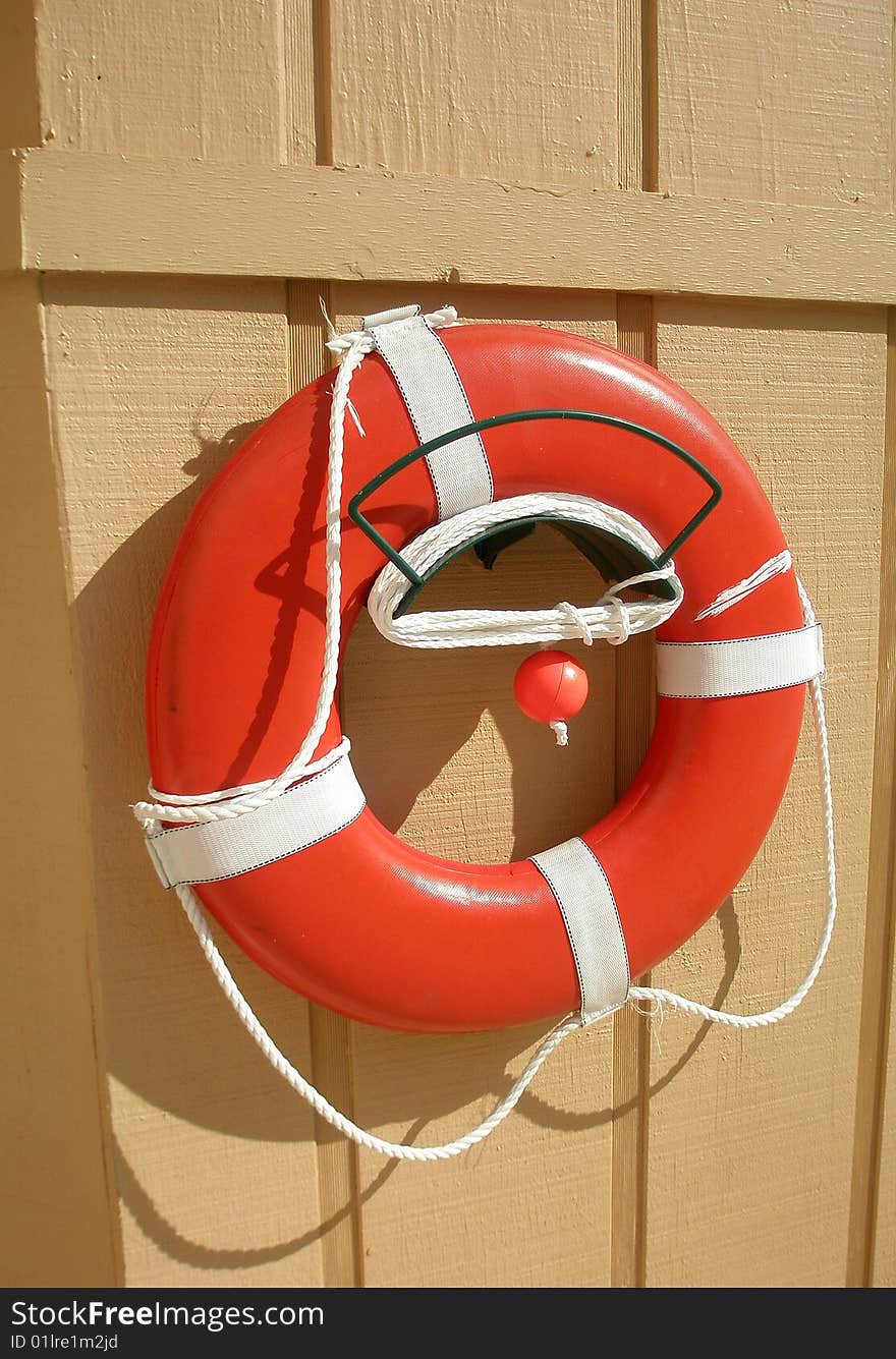 Pool life preserver hanging on wall