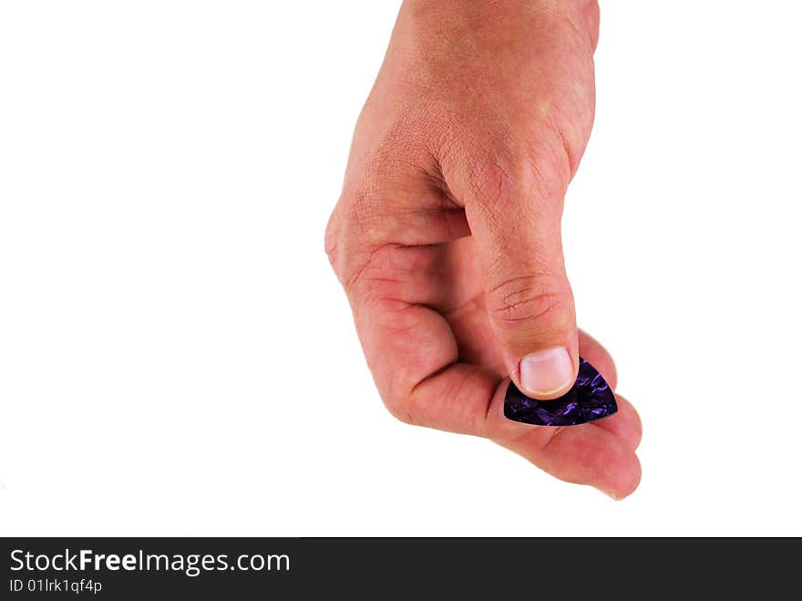 Man's hand holding a purple guitar pick, isolated on white.