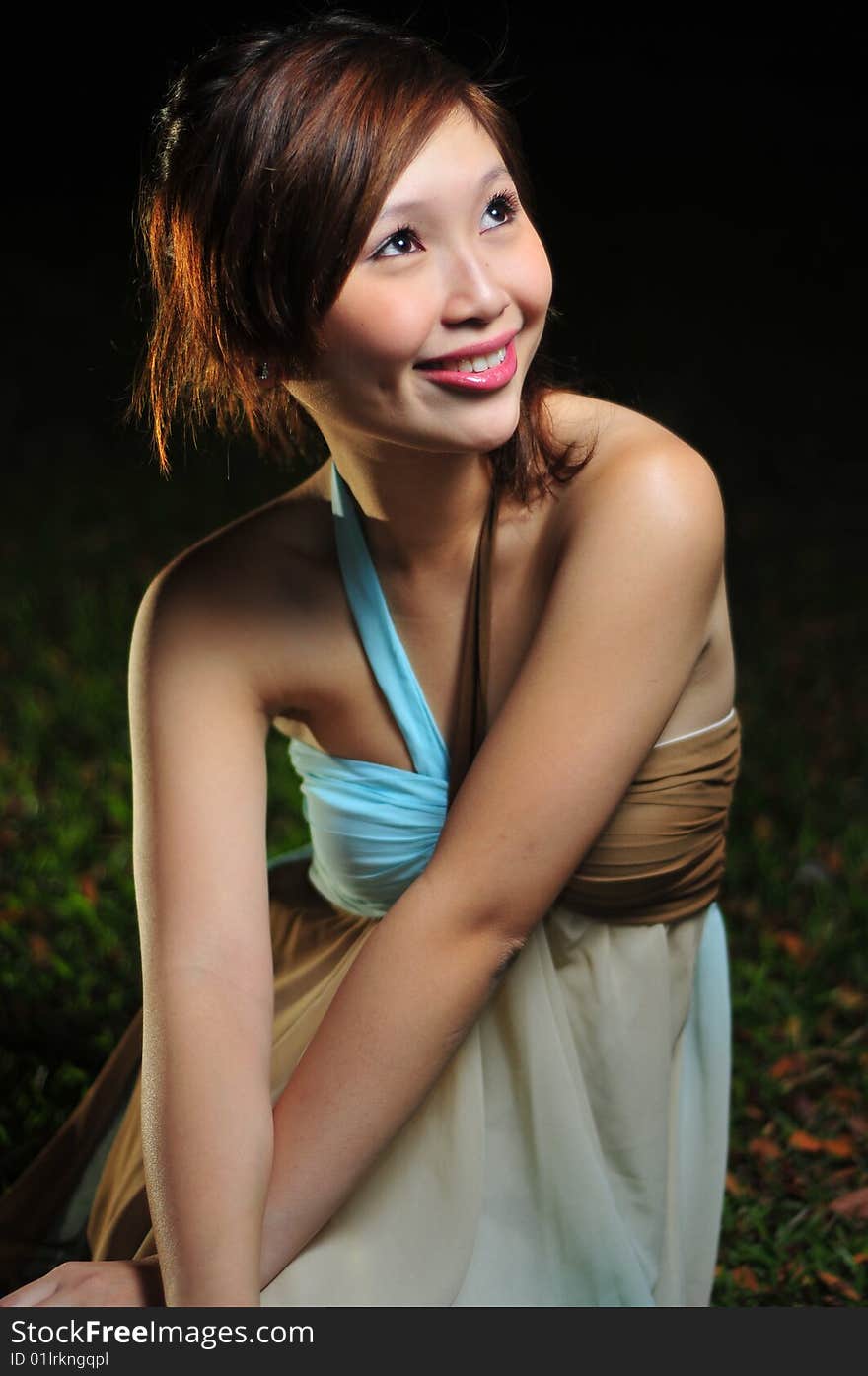 Beautiful Young Asian Woman Sitting In The Park.