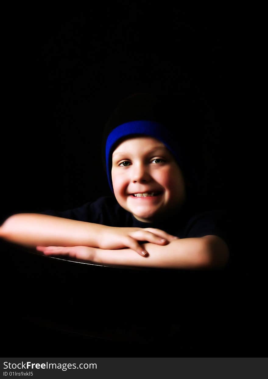 A young boy in a stocking hat posing for a portrait. A young boy in a stocking hat posing for a portrait.