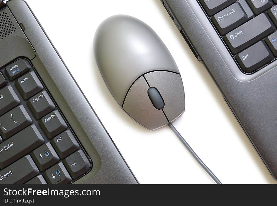 Computer mouse between two laptops