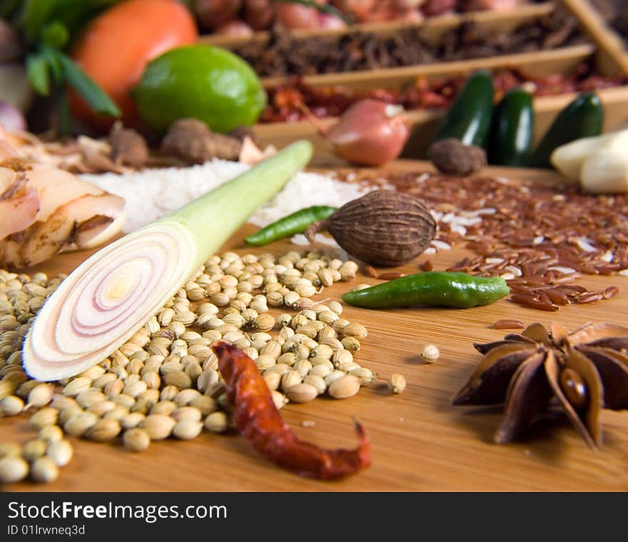 Dried red pepper, white peppercorn, and star anise with other ingredients behind. Dried red pepper, white peppercorn, and star anise with other ingredients behind