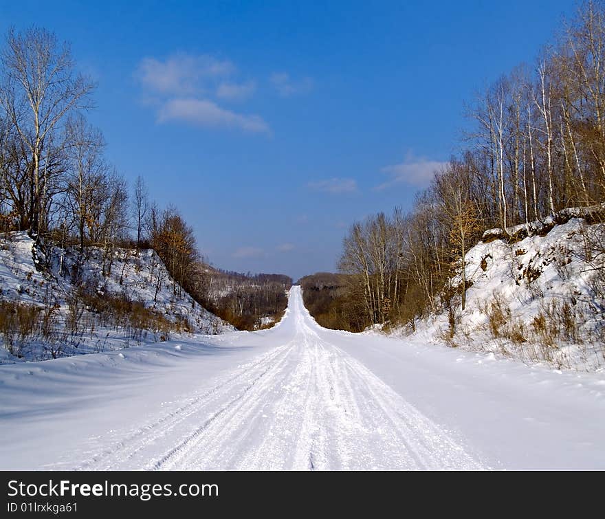 The Winter landscape road coverring snow in wood. The Winter landscape road coverring snow in wood